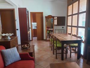 a living room with a table and a dining room at La Casa del Lago in Porlezza
