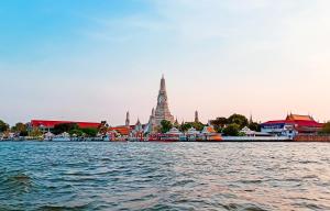 a view of a river with a temple in the background at Bangkok Siam in Bangkok