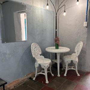 a table with two chairs and a table with a vase at La Casita de Nataly in Santa Ana