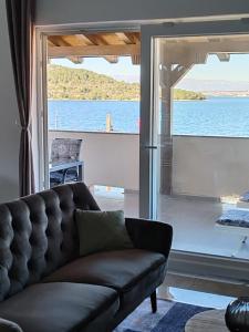 a living room with a couch and a large window at Azure Apartment in Kali