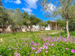 a field of flowers in front of a house at Rida Village Ksamil Island in Ksamil