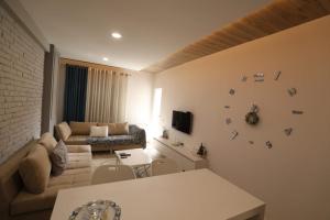 a living room with a couch and a table at Elio Apartament in Pogradec
