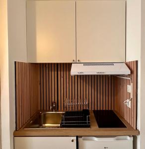 a kitchen with a sink and a stove top oven at Halte Provençale à Manosque - Centre Historique in Manosque