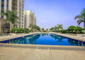 a large swimming pool in the middle of a city at Les Lavandins-Yaoundé in Yaoundé