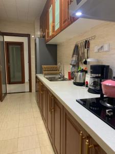 a kitchen with a sink and a counter top at Les Lavandins-Yaoundé in Yaoundé