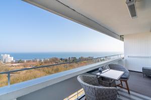 a balcony with a table and chairs and the ocean at Panoramic Sierksdorf App A12-1 in Sierksdorf