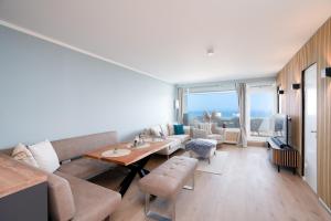a living room with a couch and a table at Panoramic Sierksdorf App A12-1 in Sierksdorf