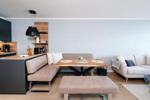 a living room with a table and a couch at Panoramic Sierksdorf App A12-1 in Sierksdorf