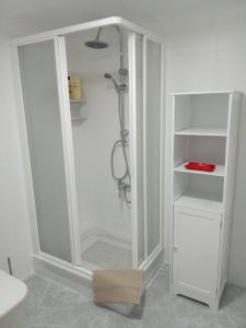 a white shower in a white bathroom with a shower at Casa Palomar in Alcaudete +21 photos