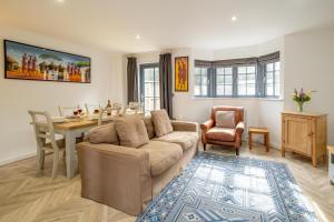 a living room with a couch and a table at 5 Oakes Court in Thorpeness