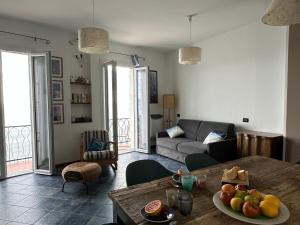 a living room with a table with fruit on it at Casa Jole in Ceriale