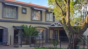 a house with a fence in front of it at Lavender Lofts in Centurion