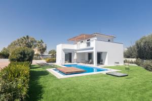 a villa with a swimming pool in a yard at Sea Satin Villas - Ayia Napa Center in Ayia Napa
