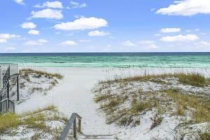 a sandy beach with the ocean in the background at Forever Coastal With Game Room And Private Beach in Destin