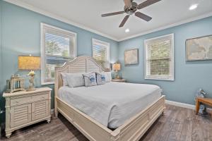 a bedroom with a bed and a ceiling fan at Forever Coastal With Game Room And Private Beach in Destin