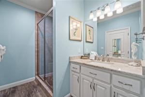 a bathroom with a sink and a shower at Forever Coastal With Game Room And Private Beach in Destin