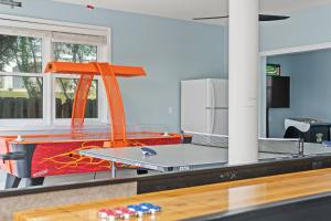a ping pong table in a room at Forever Coastal With Game Room And Private Beach in Destin