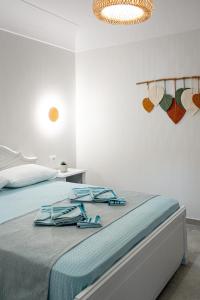 a bedroom with a bed with blue towels on it at Ostria Apartments in Akrotiri