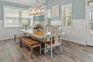 a dining room with a wooden table and chairs at Forever Coastal With Game Room And Private Beach in Destin