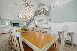 a dining room with a wooden table and chairs at Forever Coastal With Game Room And Private Beach in Destin