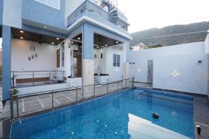 a house with a swimming pool on a balcony at Singh Villa Udaipur in Udaipur