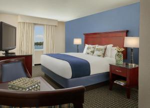 a hotel room with a bed and a television at Bristol Harbor Inn in Bristol