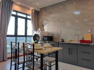 a kitchen with a table and chairs in a kitchen at Near Airport K Avenue Homestay by MINO Suites in Donggongon