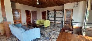 a living room with a couch and a table at Corcovado Eco Lodge Villas-Houses-Tents-Mountain-Ocean Views in Puerto Jiménez