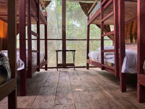 a room with two bunk beds and a wooden floor at Estación Biológica Santa María de Fátima II Zona in Iquitos +50 photos