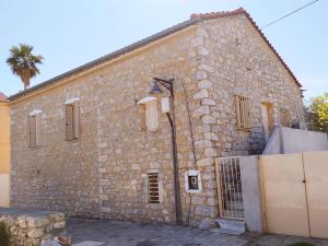 a stone building with a street light in front of it at Flame Yard in Areopoli