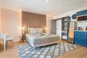 a bedroom with a bed and a table and a kitchen at Nice Renting - Love Room Massena - Luxe Room - Jacuzzi - Terrace - King Bed - AC in Nice