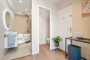 a bathroom with a tub and a sink and a toilet at Nice Renting - Love Room Massena - Luxe Room - Jacuzzi - Terrace - King Bed - AC in Nice +12 photos