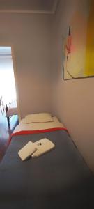 a bedroom with a bed with a towel on it at Orsiida sea view apartment Agria in Agria