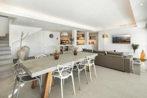 a dining room and living room with a table and chairs at Villa Angelique, 5 BDR with Heated Private Pool in Puerto Banus in Marbella