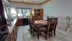 a kitchen with a table and chairs in a room at Pangolin Overnight Self-catering Accommodation cc in Windhoek