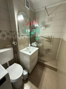 a bathroom with a toilet and a sink and a shower at Ego Residence Alba Iulia in Alba Iulia +16 photos