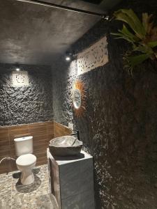 a bathroom with a toilet and a sink at Bien dormir house in Sidemen