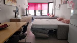 two beds in a room with a desk and a desk at Rosas in Roses