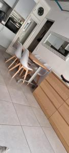 a kitchen with two white chairs and a counter at Rosas in Roses +4 photos
