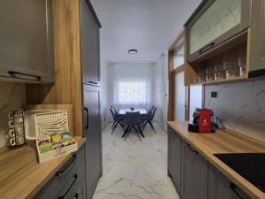 a kitchen with a table and a dining room at Apartman STRONG 2 in Slavonski Brod