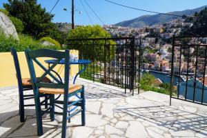 a table and chair on a patio with a view of a city at Panoramic View House in Symi