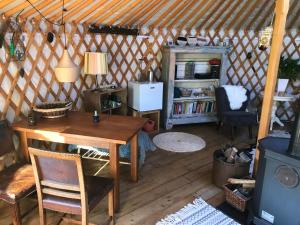 a room with a table and chairs in a yurt at YURs in Baexem +18 photos