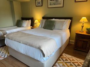 a bedroom with two beds and two lamps in it at Fennor Park Lodge in Oldcastle +56 photos