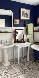 a bathroom with two sinks and a mirror and a tub at Fennor Park Lodge in Oldcastle