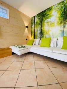 a living room with white couches and a painting on the wall at Casa di Malce in Malcesine