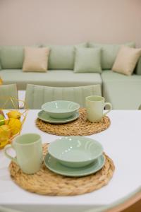 a coffee table with plates and cups on it at Arial Lofts in Vlorë