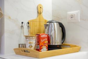 a wooden shelf with a coffee maker on a counter at Arial Lofts in Vlorë