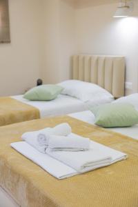 two beds with white towels on top of them at Arial Lofts in Vlorë