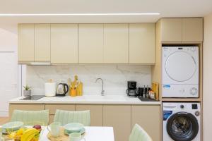 a kitchen with a sink and a washing machine at Arial Lofts in Vlorë
