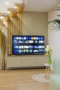 a living room with a large television on a wall at Arial Lofts in Vlorë